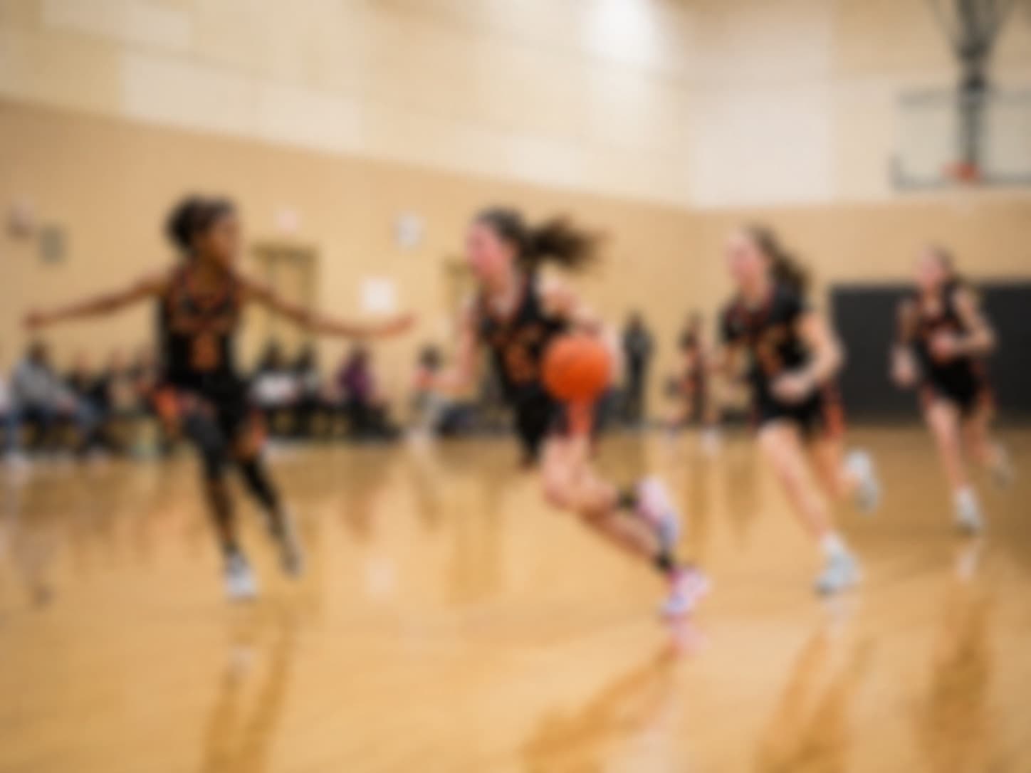 Athlete pushing the ball up the floor in a practice gym