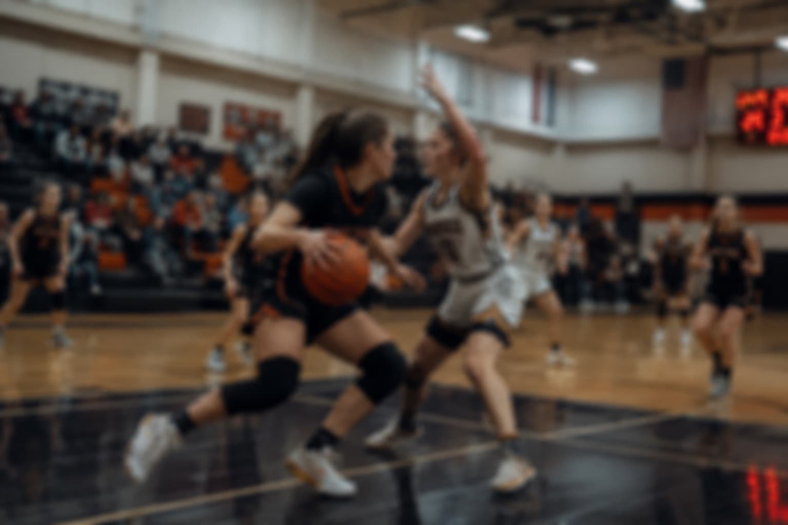 Guard attacking a defender one-on-one during a game